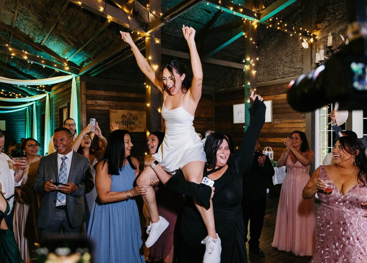 Guests lifting the groom during the Hora Loca